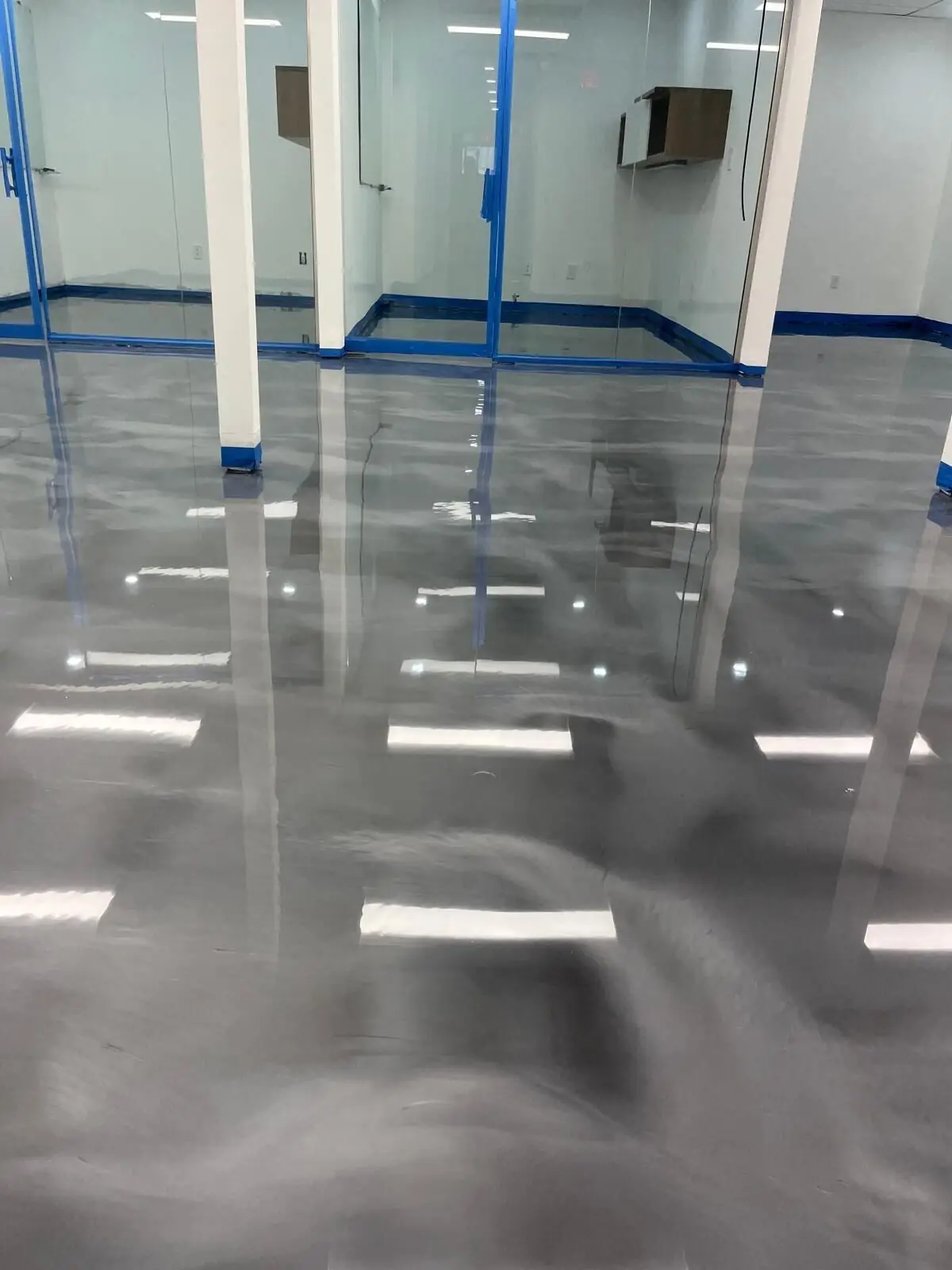 Gray metallic epoxy floor in a glass-walled office, South Florida